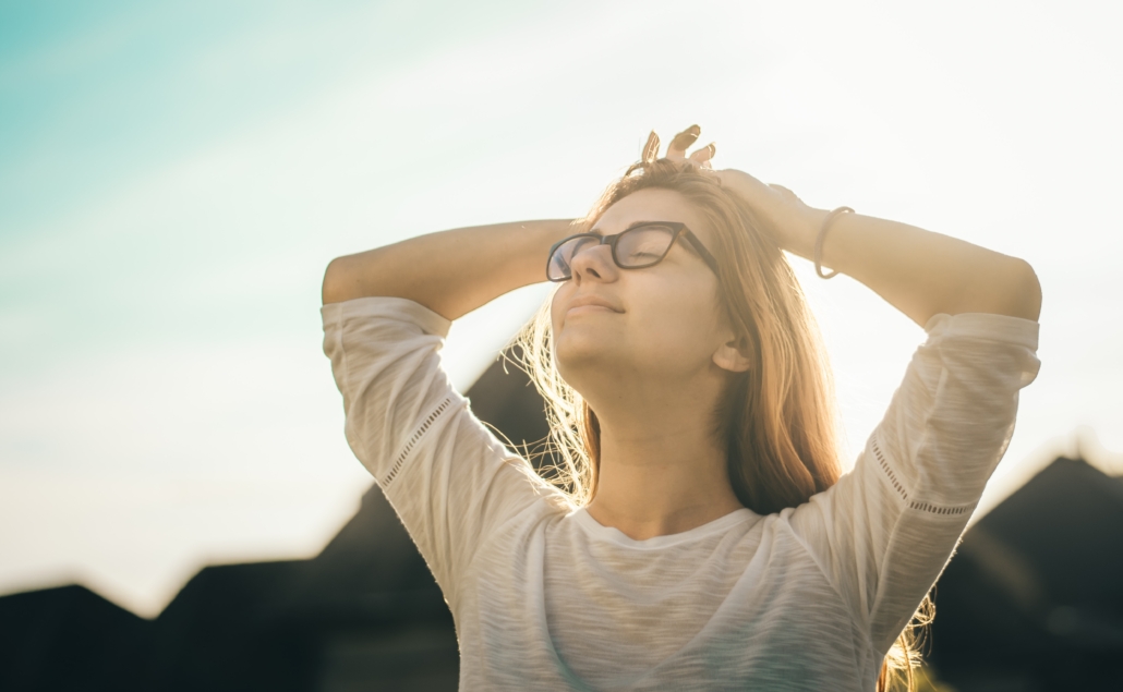 young girl with black glasses soaking up the sun