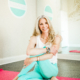 cynthia delaney smiling on a yoga mat