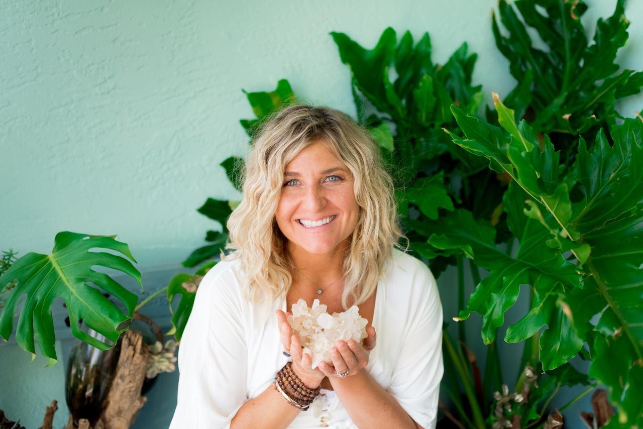 yoga teacher holding a crystal