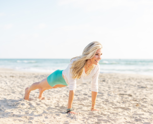 cynthia delaney doing plank on the beach